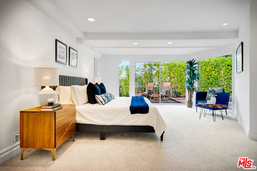 16561 Adlon Road Encino, CA 91436 - Photo 52 of 75 a bedroom with furniture and a large window