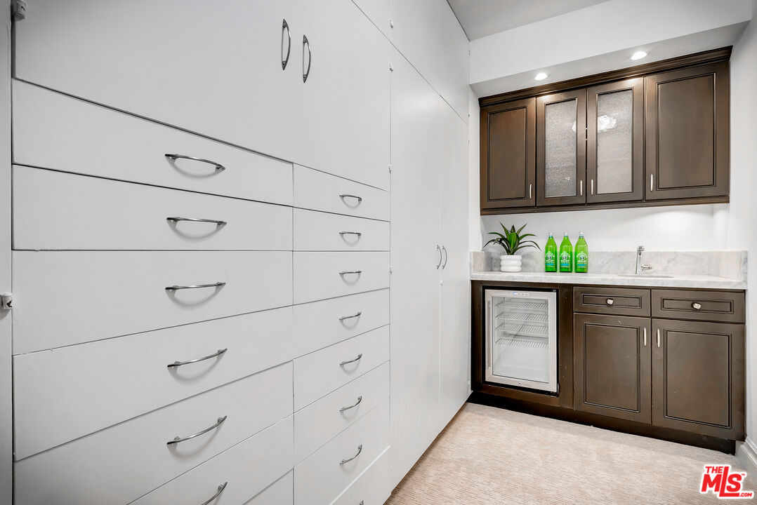 16561 Adlon Road Encino, CA 91436 - Photo 53 of 75 a kitchen with white cabinets and window