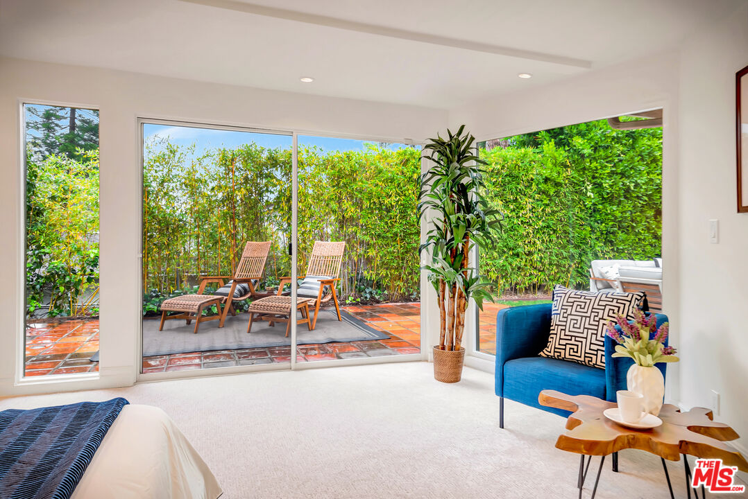 16561 Adlon Road Encino, CA 91436 - Photo 56 of 75 a living room with patio furniture and a garden