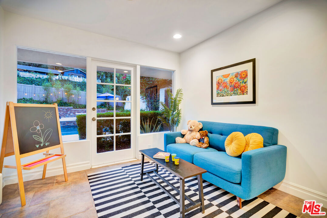 16561 Adlon Road Encino, CA 91436 - Photo 60 of 75 a living room with furniture and a floor to ceiling window