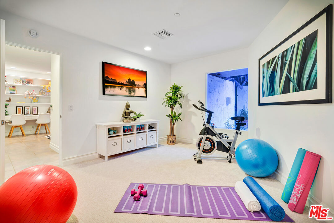16561 Adlon Road Encino, CA 91436 - Photo 62 of 75 a living room with furniture and a flat screen tv