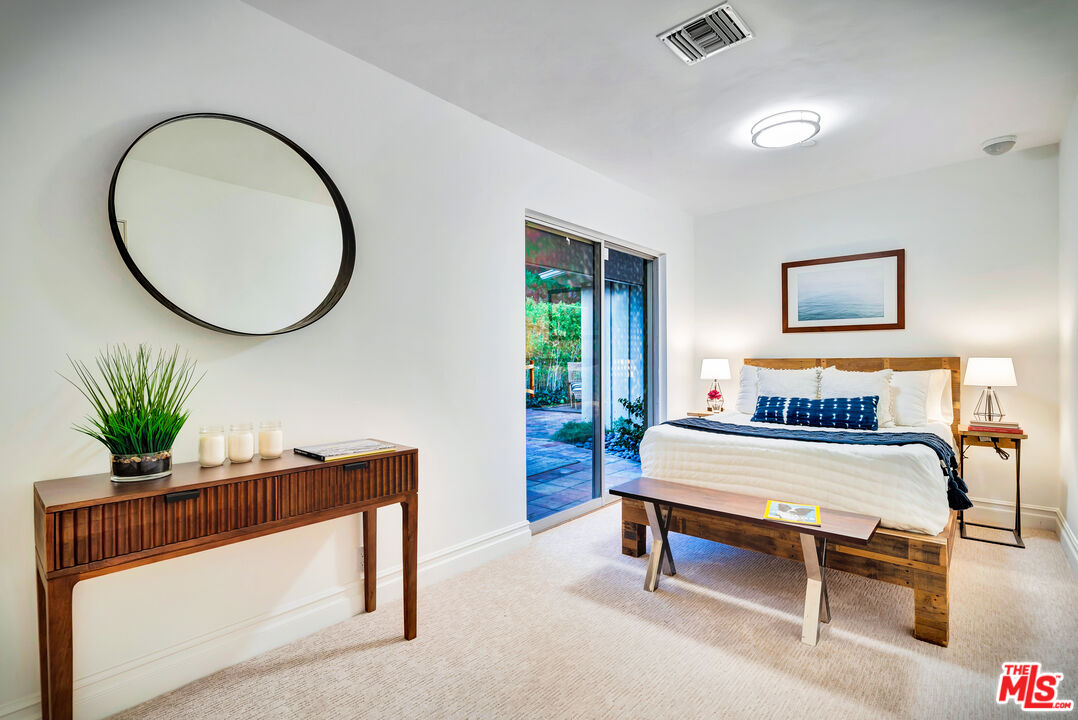 16561 Adlon Road Encino, CA 91436 - Photo 64 of 75 a living room with furniture and a potted plant