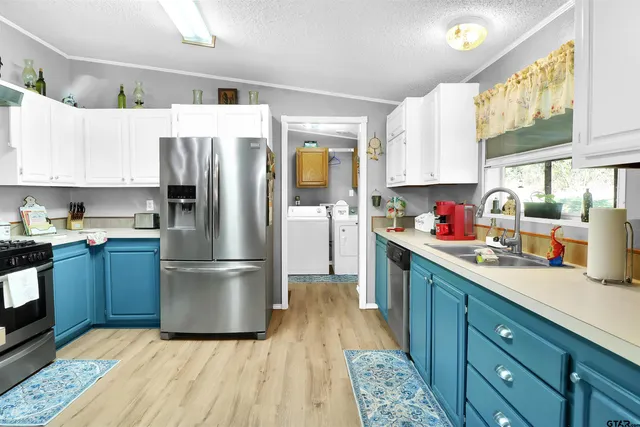 a kitchen with granite countertop a refrigerator and a sink