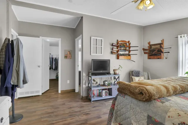 a bedroom with furniture and a flat screen tv