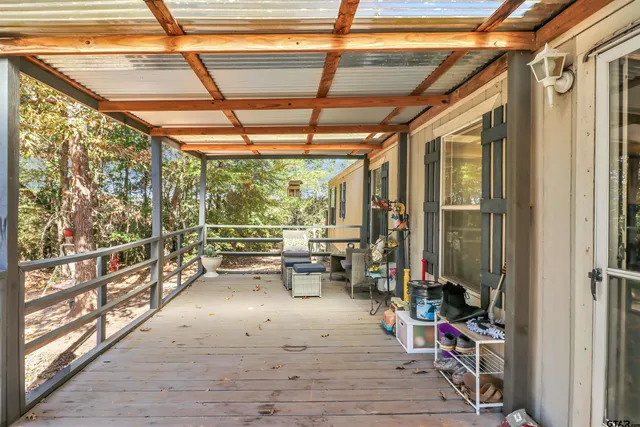 a view of outdoor space with porch and wooden floor