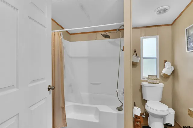 a bathroom with a shower and a toilet