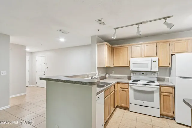 an empty room with a ceiling fan and wooden floor