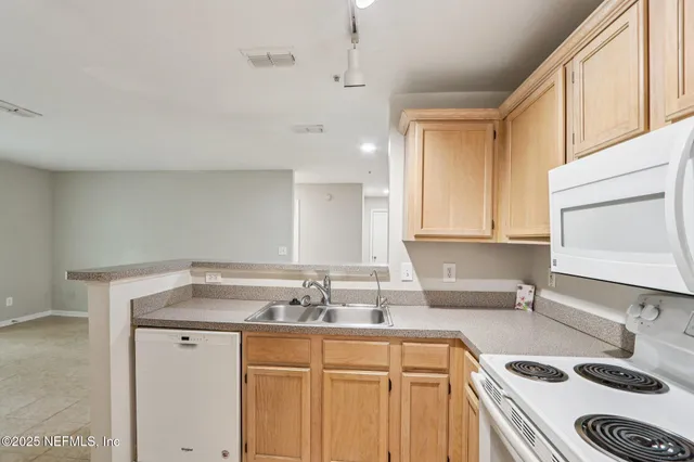 a bathroom with a granite countertop sink a toilet and a bathtub