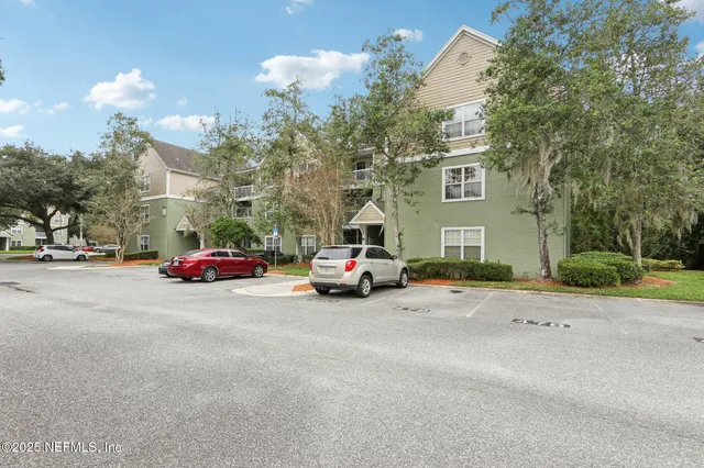 a living room with furniture a flat screen tv and a large window
