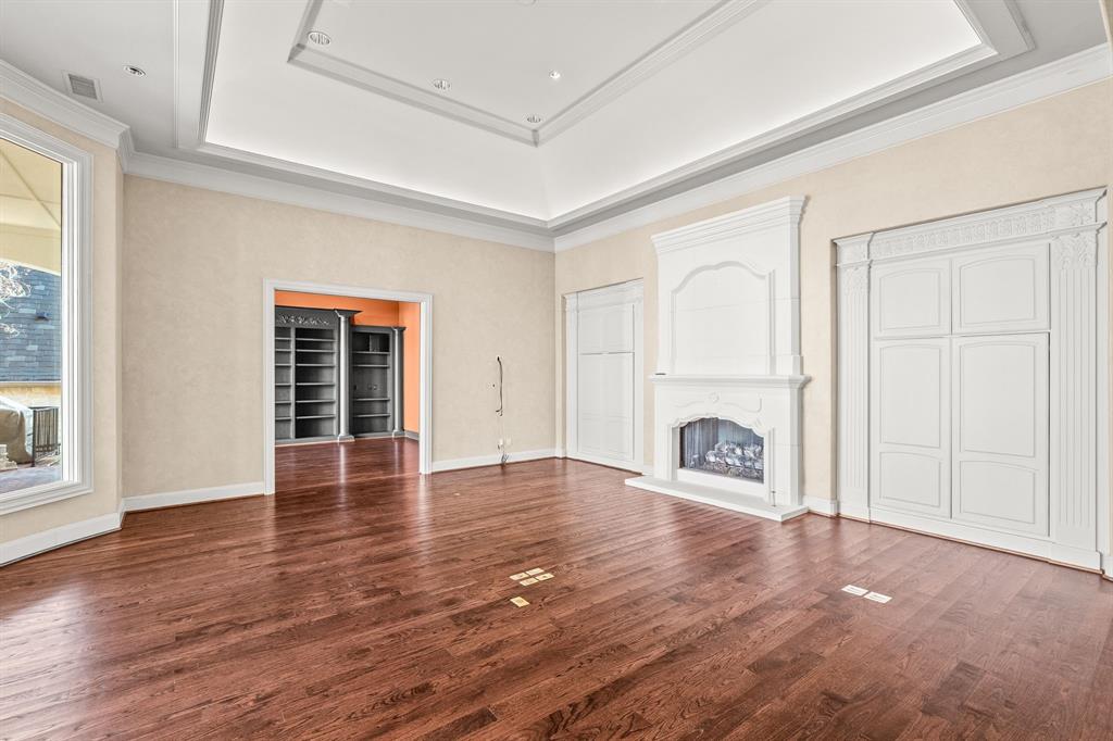 4624 Byron Circle Irving, TX 75038 - Photo 20 of 39 an empty room with wooden floor fireplace and windows