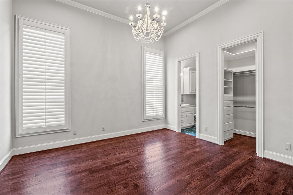 4624 Byron Circle Irving, TX 75038 - Photo 31 of 39 an empty room with wooden floor chandelier and windows