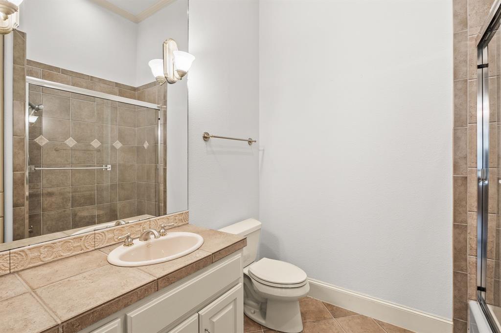 4624 Byron Circle Irving, TX 75038 - Photo 38 of 39 a bathroom with a double vanity sink toilet and shower