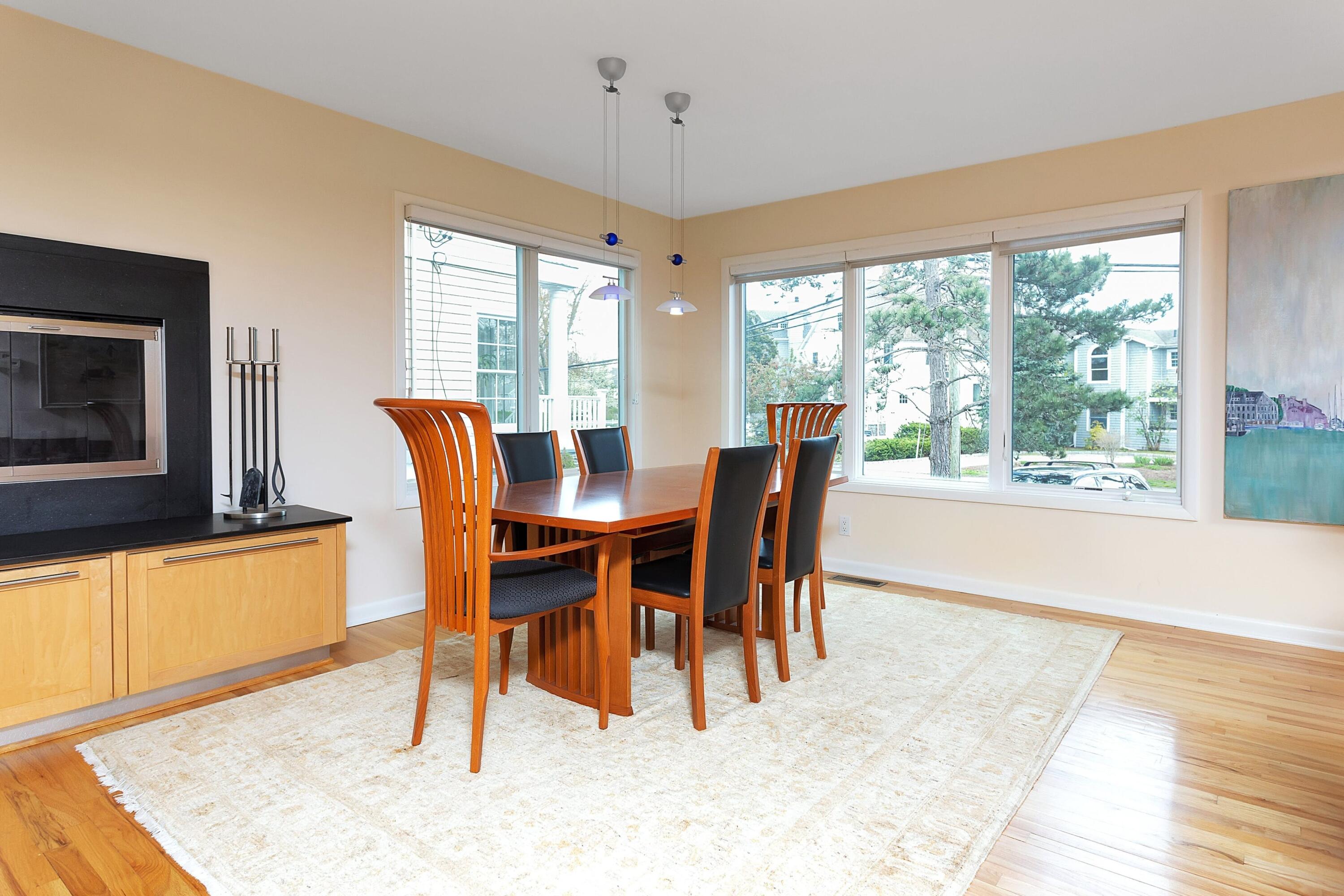 90 Roton Avenue Norwalk, CT 06853 - Photo 12 of 33 a dining room with furniture a fireplace and wooden floor