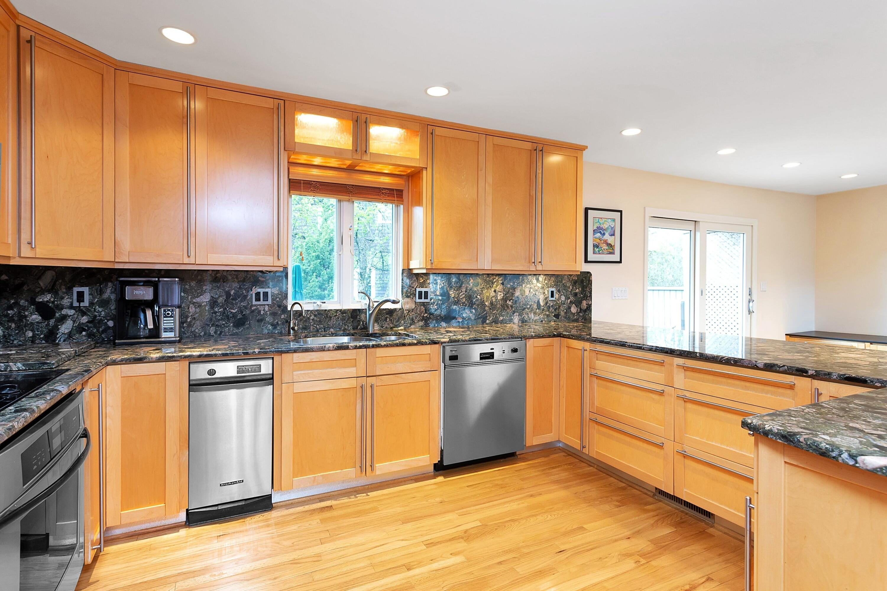 90 Roton Avenue Norwalk, CT 06853 - Photo 15 of 33 a kitchen with stainless steel appliances granite countertop a stove a sink and a microwave