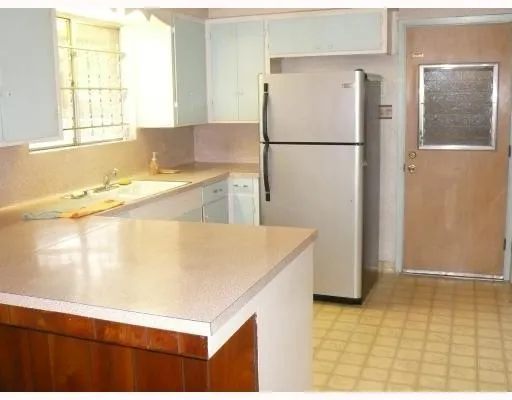 a white refrigerator freezer sitting in a kitchen