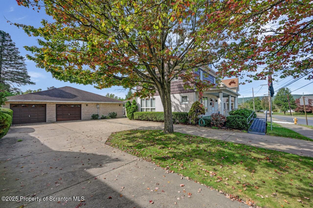 624 Main Street Moosic, PA 18507 - Photo 11 of 78 a front view of a house with a garden