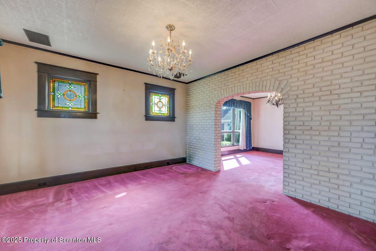 624 Main Street Moosic, PA 18507 - Photo 18 of 78 a view of an empty room with chandelier and wooden floor