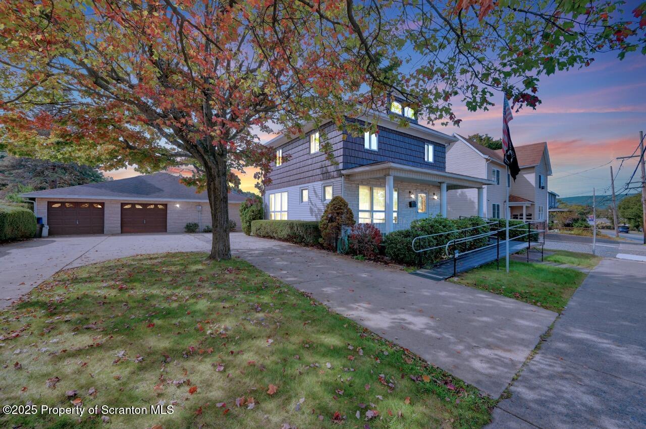 624 Main Street Moosic, PA 18507 - Photo 2 of 78 a front view of a house with a garden and trees