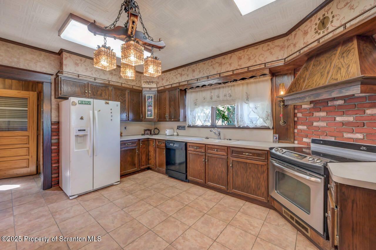 624 Main Street Moosic, PA 18507 - Photo 25 of 78 a kitchen with a stove a refrigerator and a sink