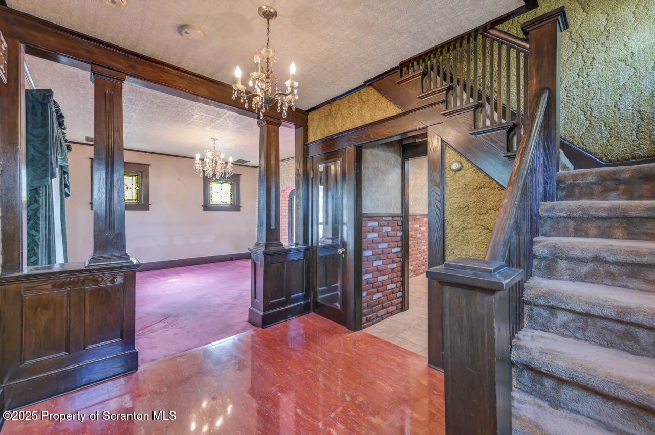 624 Main Street Moosic, PA 18507 - Photo 31 of 78 a view of a hallway with wooden floor and staircase