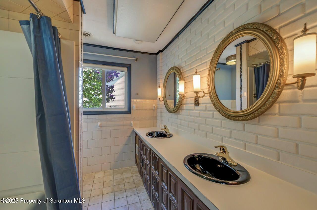 624 Main Street Moosic, PA 18507 - Photo 40 of 78 a bathroom with a sink a toilet and a mirror