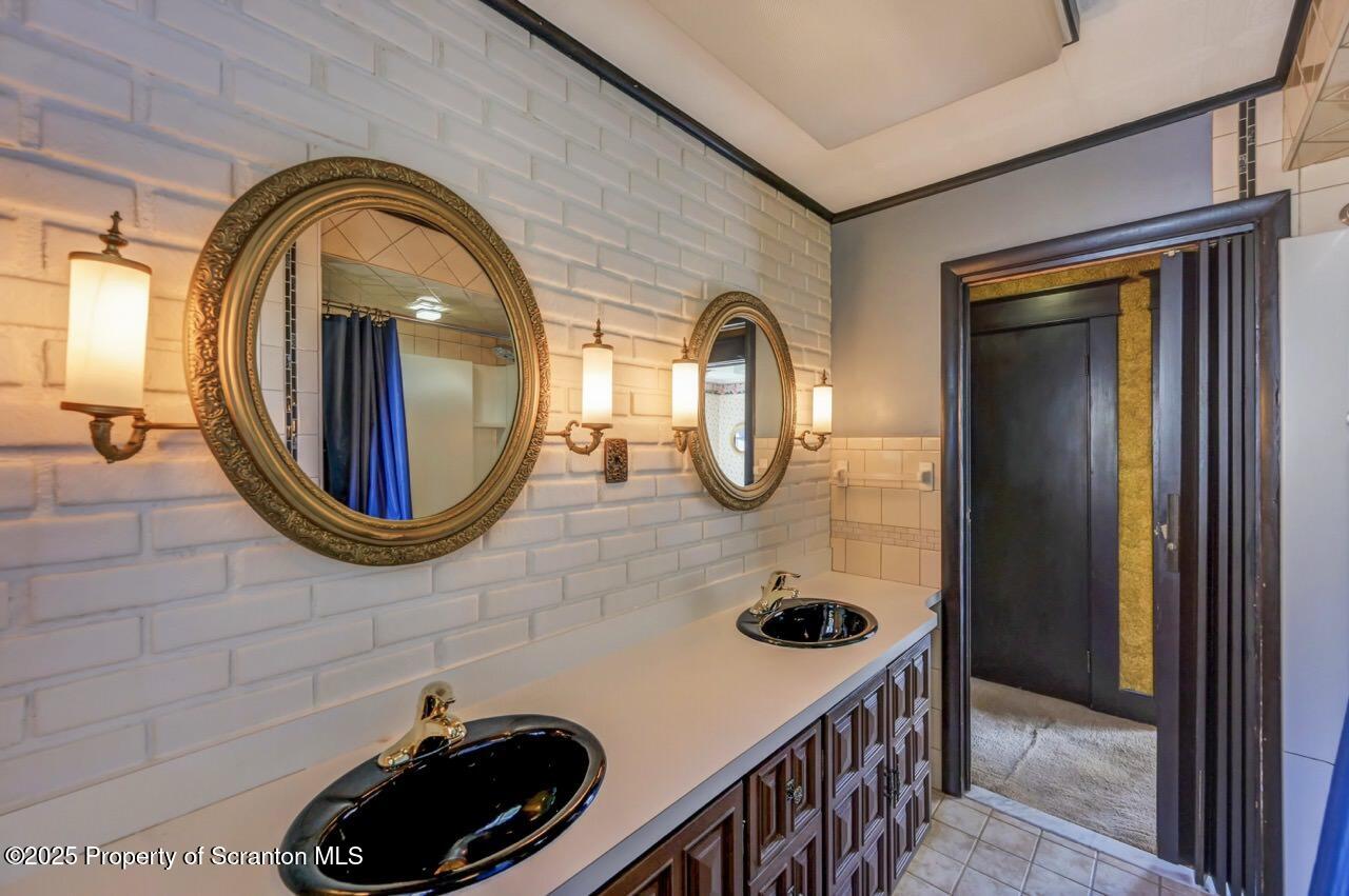 624 Main Street Moosic, PA 18507 - Photo 41 of 78 a bathroom with a sink a mirror and shower