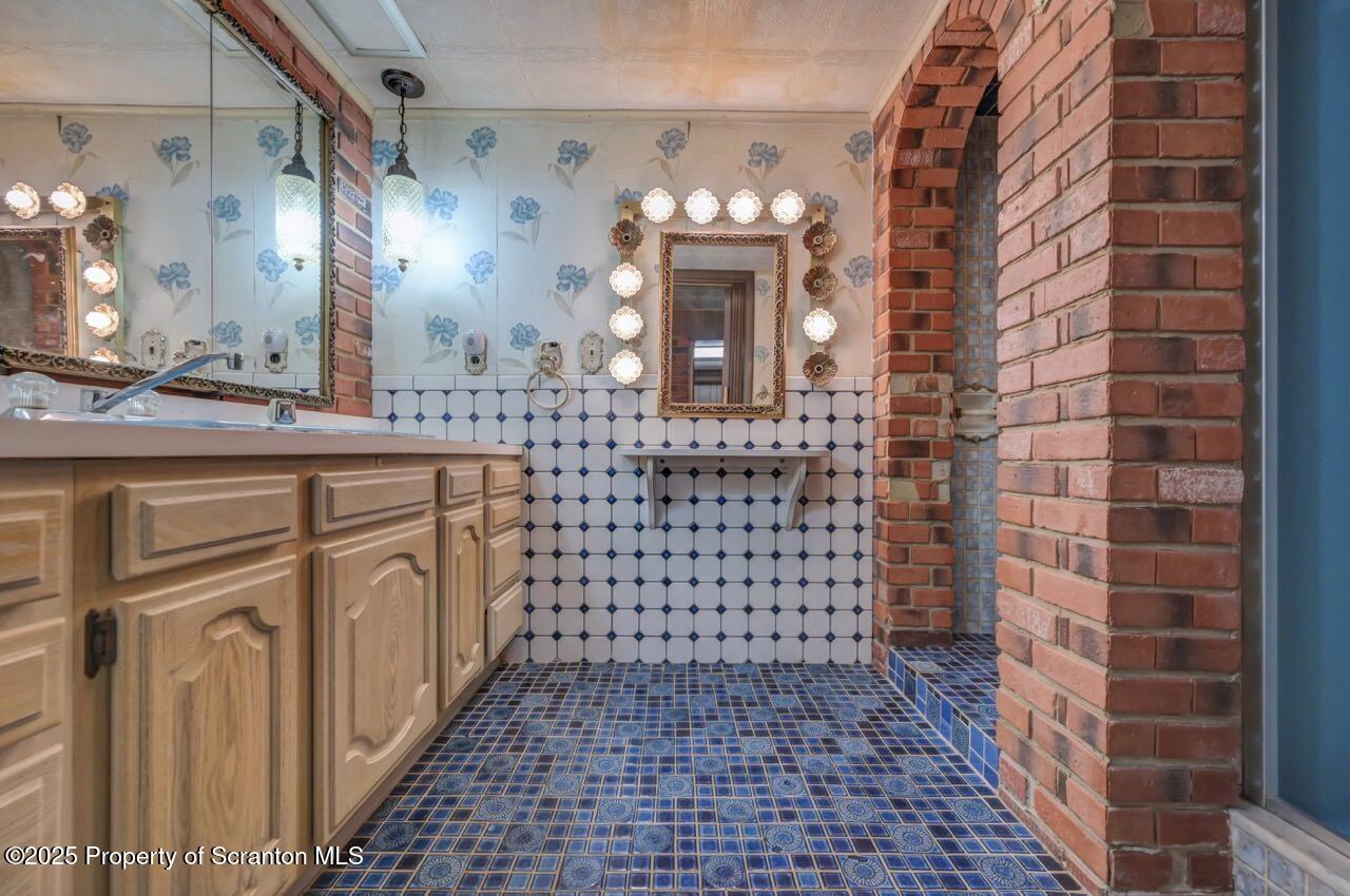 624 Main Street Moosic, PA 18507 - Photo 48 of 78 a bathroom with a sink a vanity and a mirror