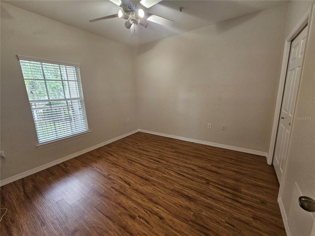 5174 Northridge Road, Unit 209 Sarasota, FL 34238 - Photo 10 of 25 wooden floor in an empty room with a window