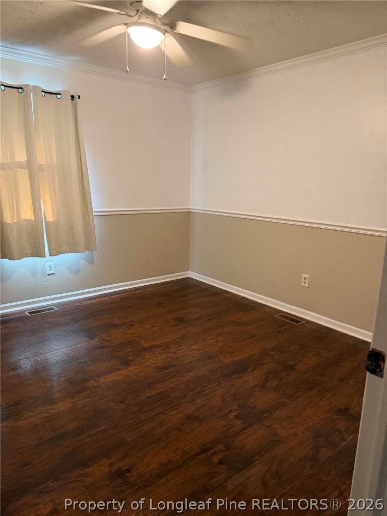 634 Dallas Road Lumberton, NC 28358 - Photo 17 of 27 an empty room with wooden floor and fan