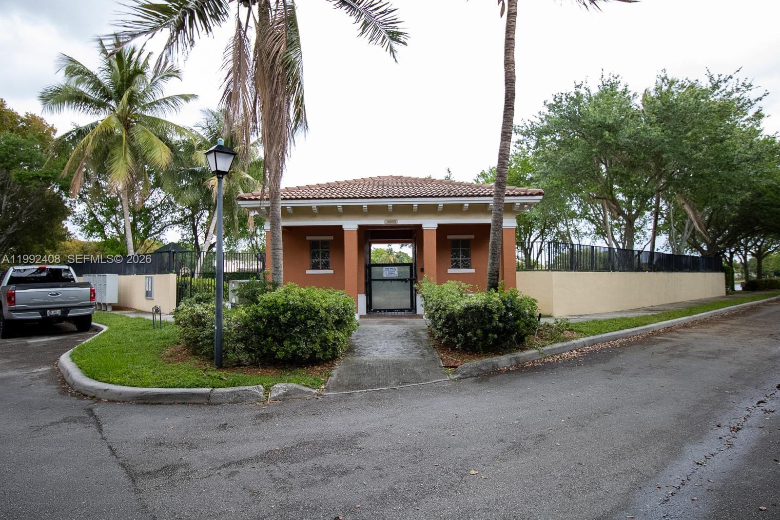 2607 Southwest 99th Way Miramar, FL 33025 - Photo 47 of 50 a front view of house with yard and green space