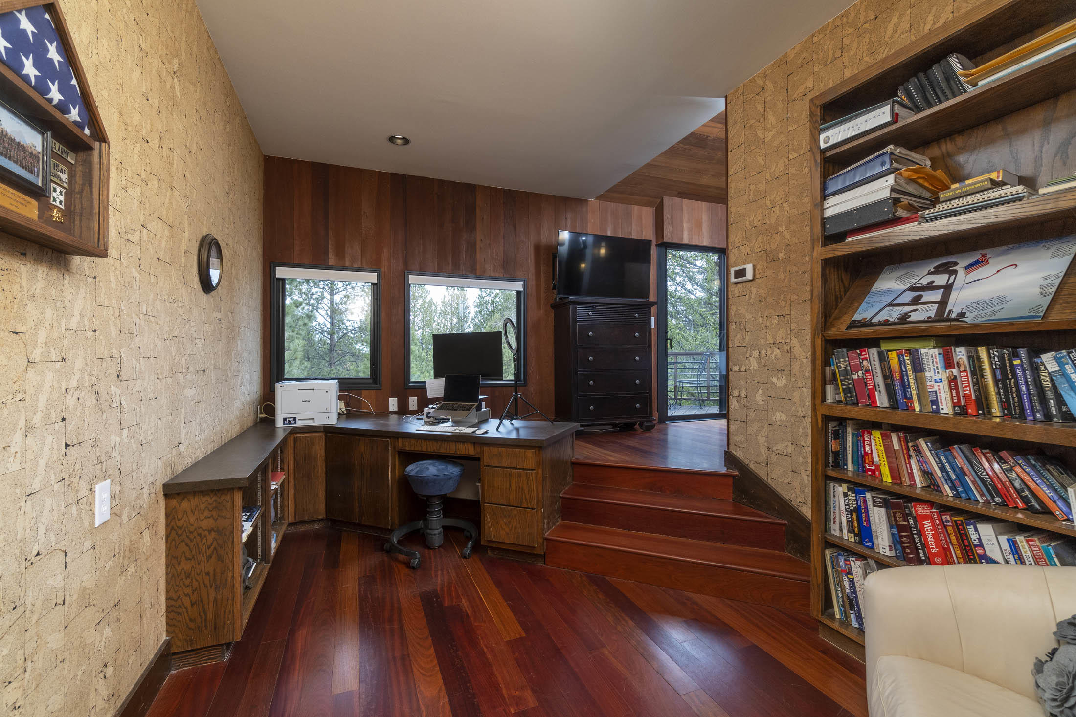 60010 East Ridgeview Drive Bend, OR 97702 - Photo 19 of 43 a view of a workspace with furniture bookshelf and wooden floor