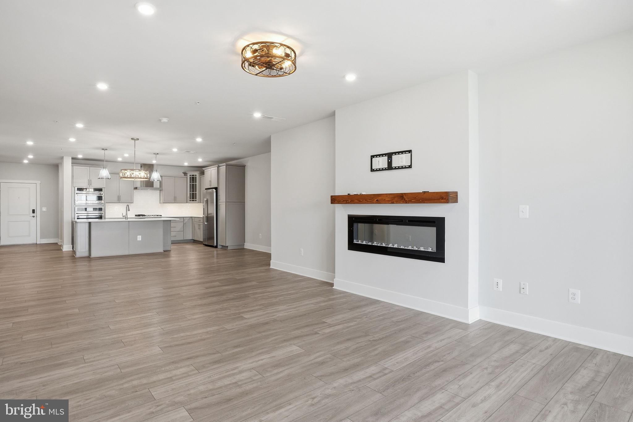 111 Marshgrass Way, Unit 22 Chester, MD 21619 - Photo 11 of 102 a view of a kitchen with a stove cabinets and wooden floor