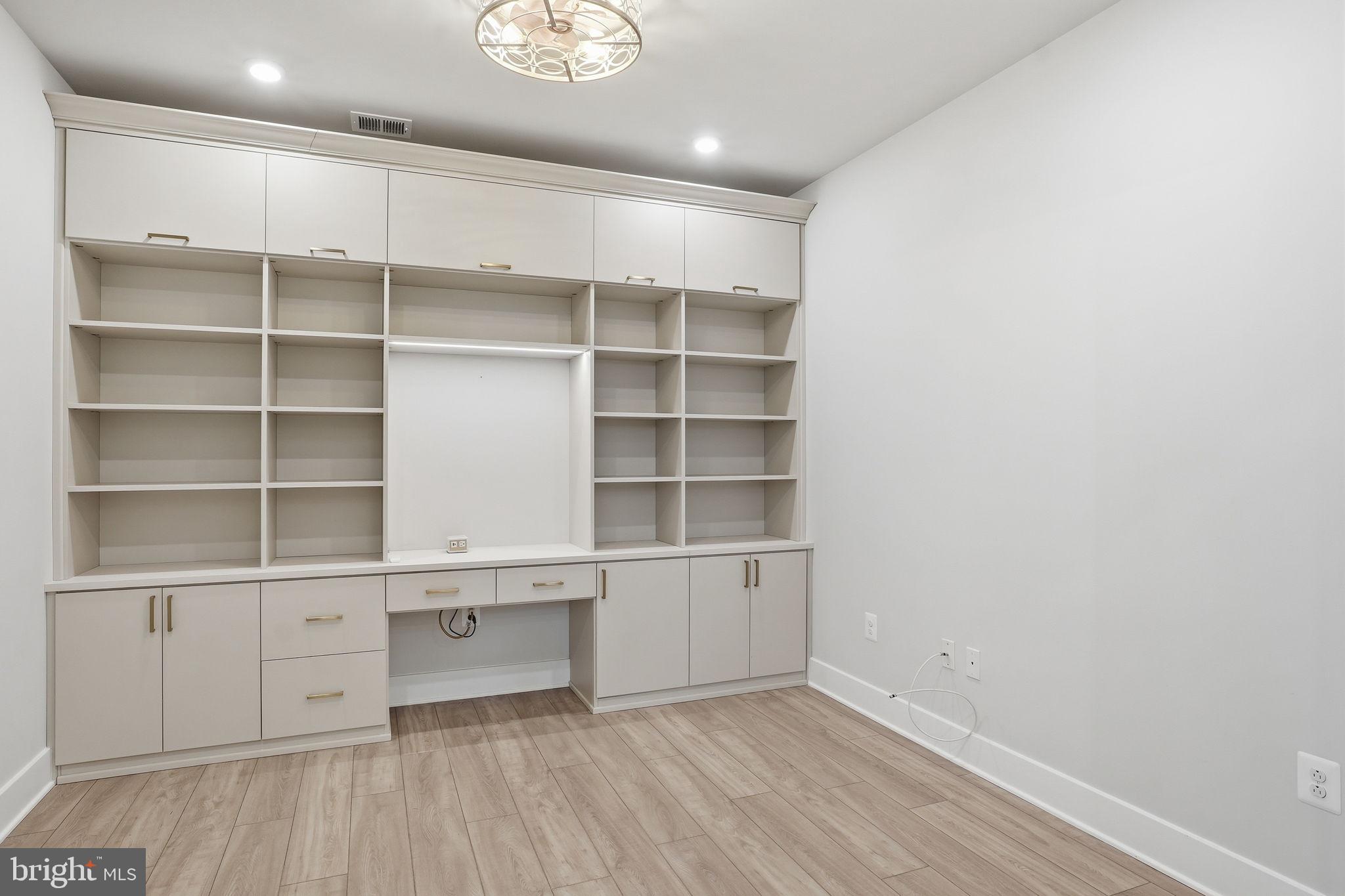 111 Marshgrass Way, Unit 22 Chester, MD 21619 - Photo 15 of 102 a view of an empty room with empty racks