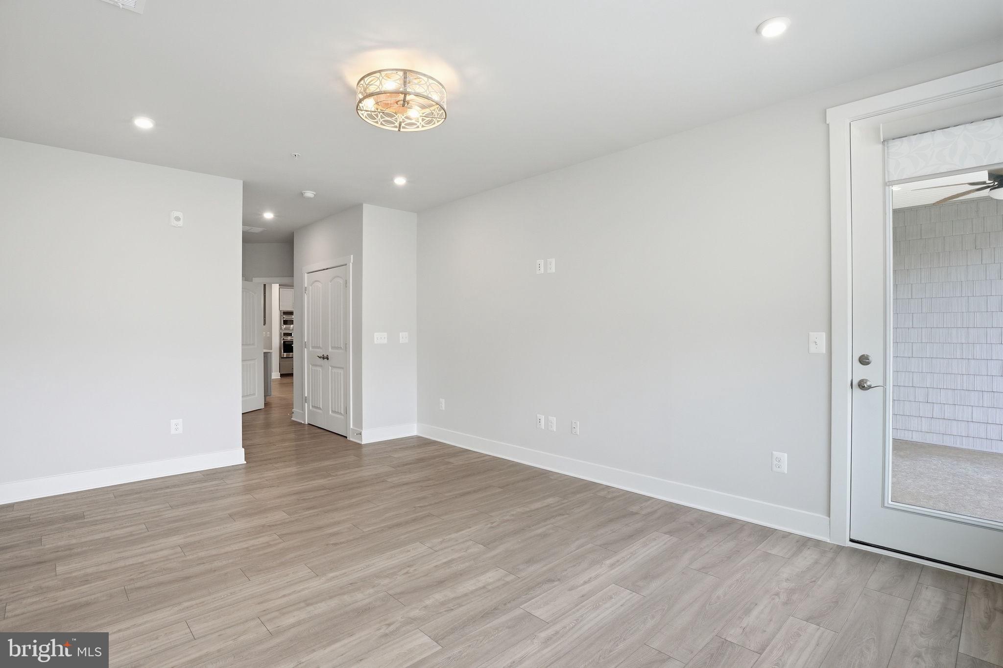 111 Marshgrass Way, Unit 22 Chester, MD 21619 - Photo 18 of 102 a view of an empty room with wooden floor