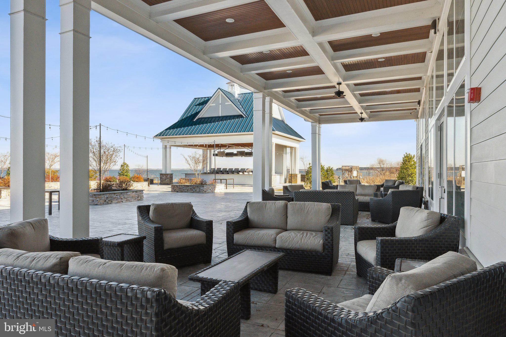 111 Marshgrass Way, Unit 22 Chester, MD 21619 - Photo 78 of 102 a living room with furniture and a floor to ceiling window