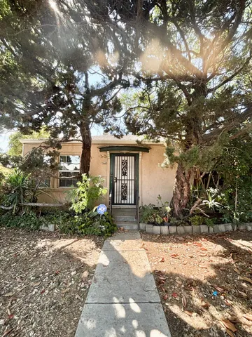 a front view of a house with a yard and a garden