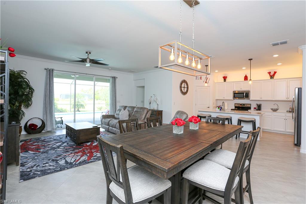 2155 Hamlin Street Naples, FL 34120 - Photo 41 of 50 Dining space featuring crown molding, light tile patterned floors, sink, and ceiling fan