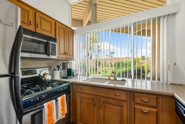a kitchen with a stove a sink and a microwave
