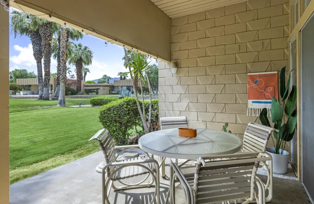 a view of a patio with table and chairs and potted plants