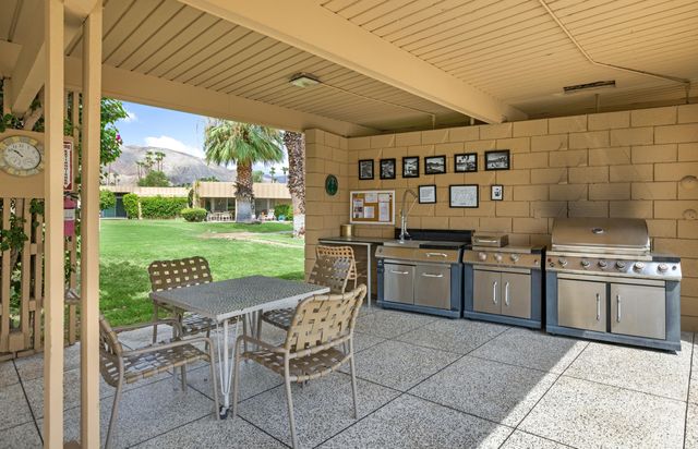 a open kitchen with a stove a sink and a refrigerator