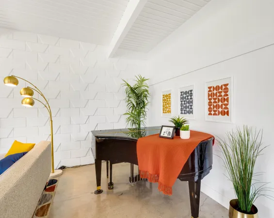 a dining room with furniture and a potted plant