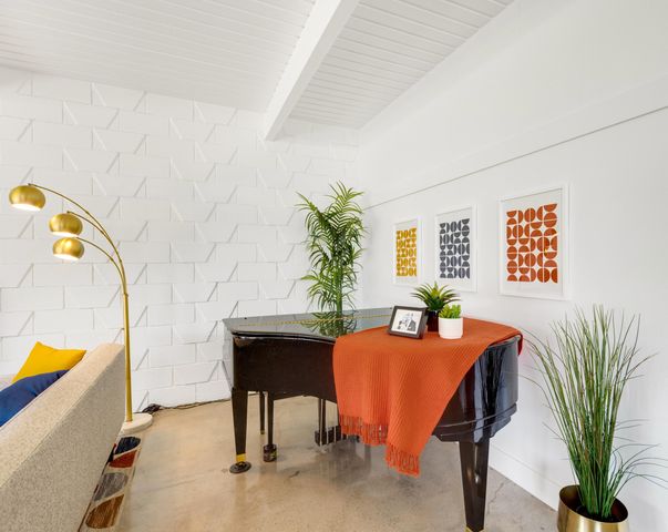 a dining room with furniture and a potted plant