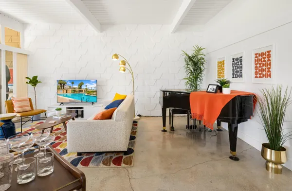 a living room with furniture and a potted plant