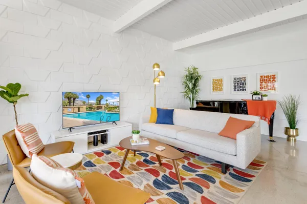 a living room with furniture and flat screen tv