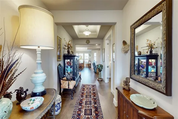 a hallway with dining table and chairs