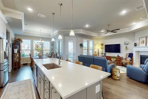 a large kitchen with kitchen island a sink table and chairs