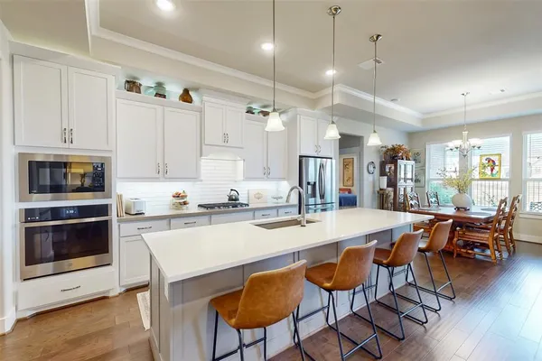 a large kitchen with a table and chairs in it