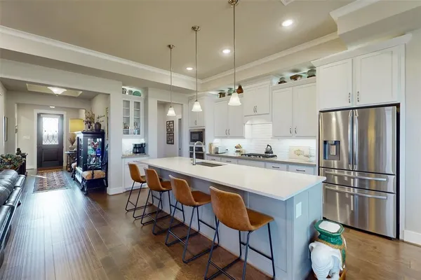 a large kitchen with a table and chairs