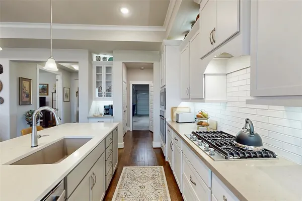 a kitchen with a sink stove top oven and refrigerator
