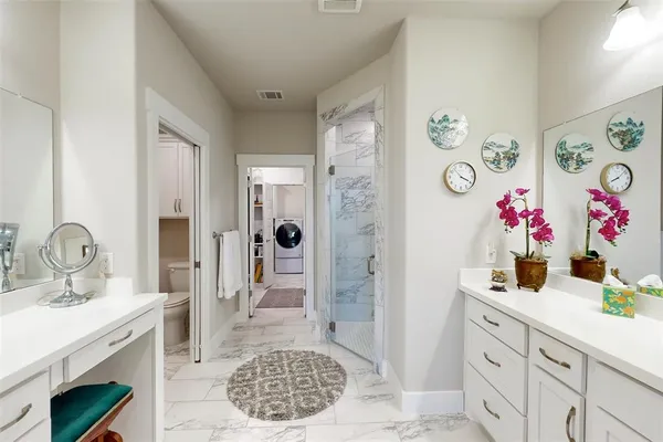 a spacious bathroom with double vanity and a mirror